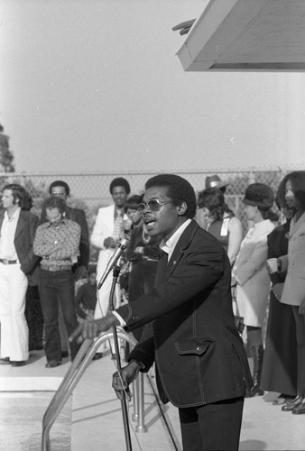 Man speaking at a microphone at an event to honor Bayard Rustin, 1973