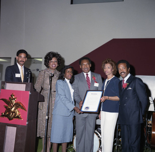 Ed and Gen Lara holding a commendation, Los Angeles