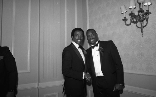 Doug Williams and Jim Hill posing together at a 100 Black Men tribute, Los Angeles, 1988