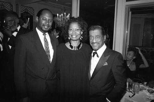 Sammy Davis, Jr. posing with others at the Black Emmy nominees dinner, Los Angeles, 1989