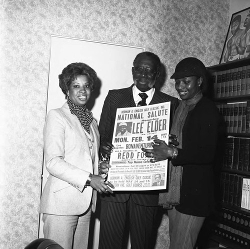 Herman English holding a poster announcing a dinner honoring Lee Elder, Los Angeles, 1977