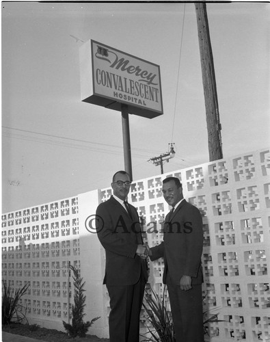 Two men shaking hands, Los Angeles, 1963