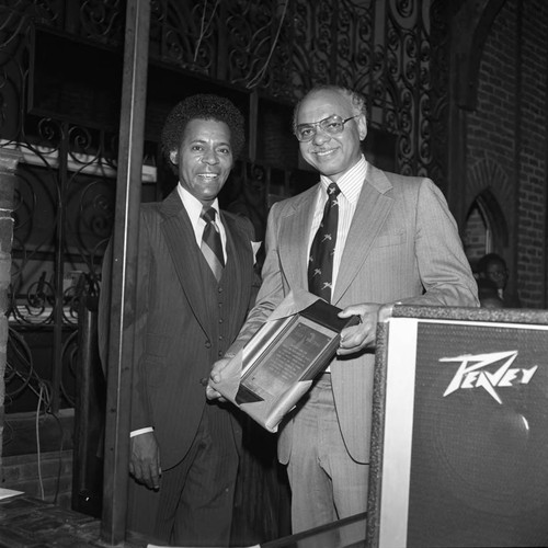 Larry McCormick receiving an award from Ivan J. Houston at the Los ...