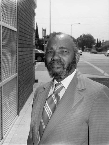 Robert Brock posing on a street corner, Los Angeles, 1983