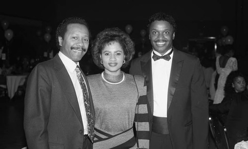 Woman posing with two men at a formal event, Los Angeles, 1987