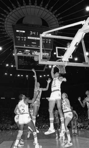 Kareem Abdul-Jabbar blocking a shot at the basket by Marques Johnson during the NBA All-Star Game, Inglewood, California, 1983