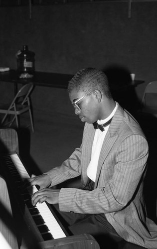 Young man playing the piano at the California Museum of Science and Industry, Los Angeles, 1986