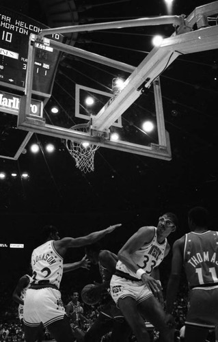 Kareem Abdul Jabbar and Magic Johnson blocking the basket during the NBA All-Star Classic, Inglewood, 1983