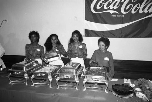 Coca-Cola sponsored event participants serving food, Los Angeles, 1984