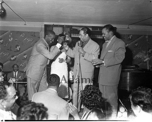 Duke Ellington toasting Elihu "Black Dot" McGee at the Tiffany Club, Los Angeles, 1956