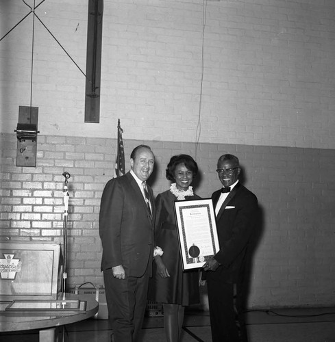 Lionel B. Cade receiving a resolution from Yvonne Brathwaite and Larry Townsend, Los Angeles, 1969