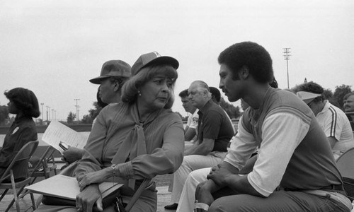 Ethel Bradley talking with others during the Dodgers Watts Clinic at Will Rogers Park, Los Angeles, 1983