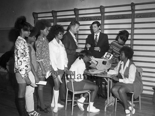 Men and women at machine, Los Angeles, 1970