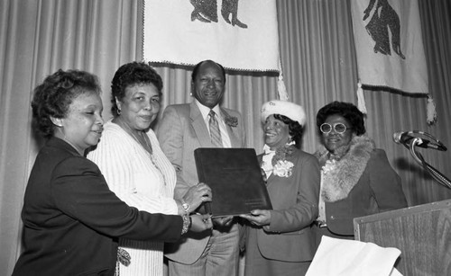 Los Angeles Alumnae Chapter of Delta Sigma Theta members holding an album with Tom Bradley, Los Angeles, 1983