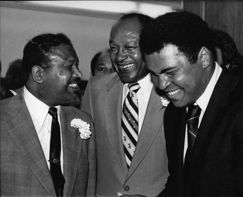 Sugar Ray Robinson, Tom Bradley, and Muhammad Ali talking together, Los Angeles, 1979