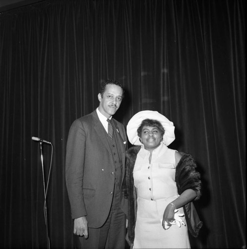 Channing E. Phillips and a woman posing together during a mayoral campaign event for Tom Bradley, Los Angeles, 1969