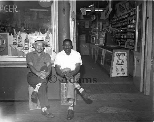 Men sitting at storefront, Los Angeles, ca. 1955