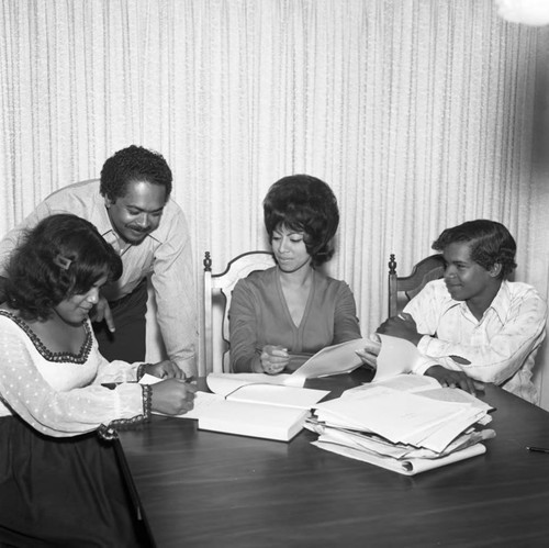 Mervyn Dymally reviewing his daughter Lynn's paperwork, Los Angeles, 1973