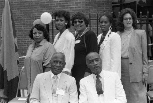 Women and men posing together at the opening of the Delta Sigma Theta Senior Center, Los Angeles, 1987