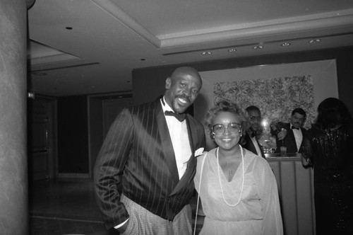 Black Emmy nominee Lou Gossett Jr. posing with an unidentified woman, Los Angeles, 1987