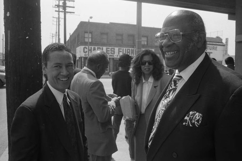 Paul C. Hudson talking with an unidentified man after a press conference, Los Angeles, 1992