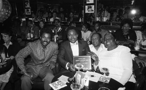 George Benson posing with an award at a nightclub, Los Angeles, 1987