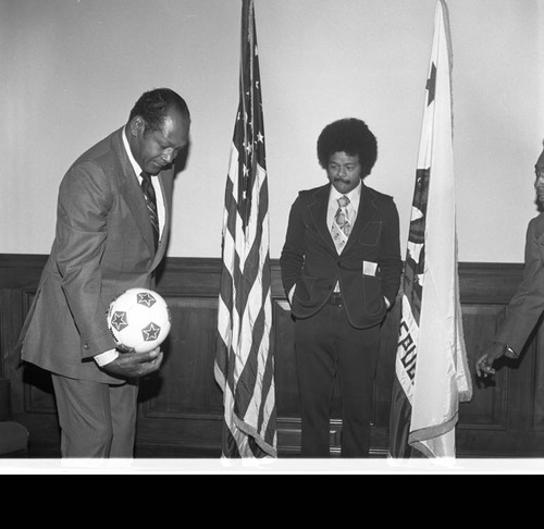 Mayor Tom Bradley balancing a soccer ball during a visit from Pelé, Los Angeles, 1975