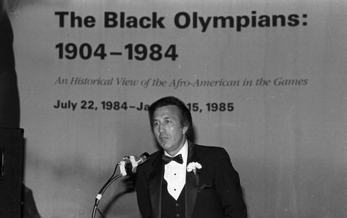 Speaker addressing an audience at the California African American Museum exhibit "The Black Olympians," Los Angeles, 1985