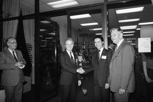 Paul C. Hudson posing with three unidentified men during an event at Broadway Federal Savings and Loan, Los Angeles, 1984