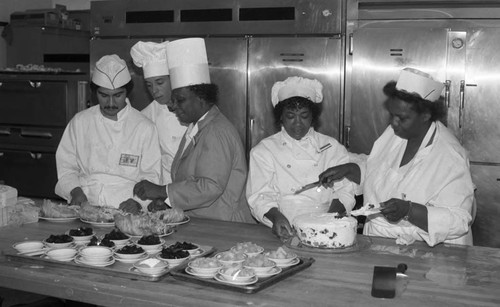 Culinary art students preparing food in a commercial kitchen, Los Angeles, 1985