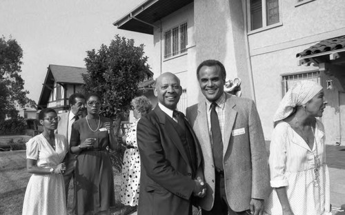 Harry Belafonte posing with others at a reception in his honor, Los Angeles, 1983