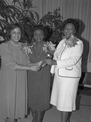 Theta Mu Omega Basileus Billie Barrett passing her gavel to Yvonne Lee, Los Angeles, 1983