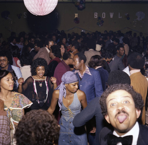 Connie Thompson dancing among guests at a Super Bowl party, Los Angeles, 1977