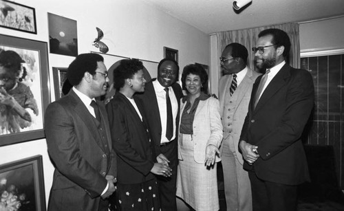 Guests at a Kelli Flowers cocktail party posing together, Los Angeles, 1983