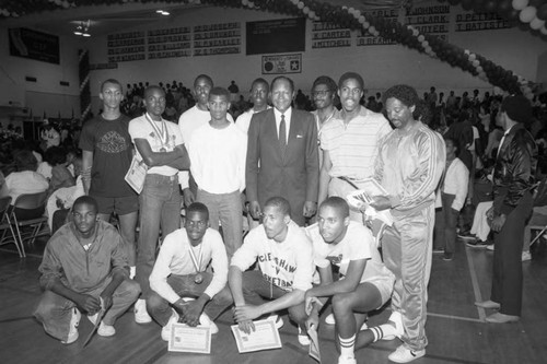 Crenshaw High School basketball team posing for a group portrait with Tom Bradley, Los Angeles, 1985