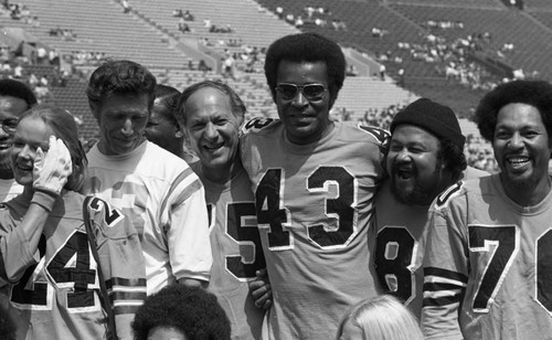 Participants of the Urban League's Celebrity All-Star Freedom Classic pre-game posing together, Los Angeles, 1973