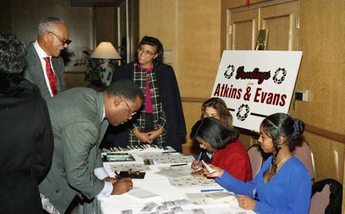 Atkins & Evans holiday party guests making name tags, Los Angeles, 1994