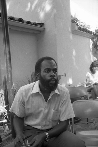 Man sitting with a notebook at a Los Angeles Press Club event, Los Angeles, 1983