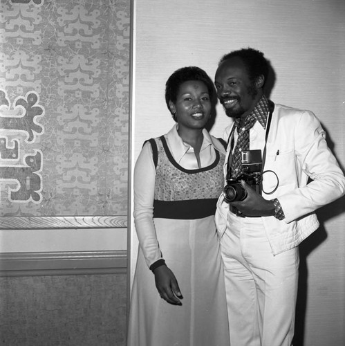 Willie Brown, Jr. posing with a woman at the California Black Elected Officials Conference, Los Angeles, 1973