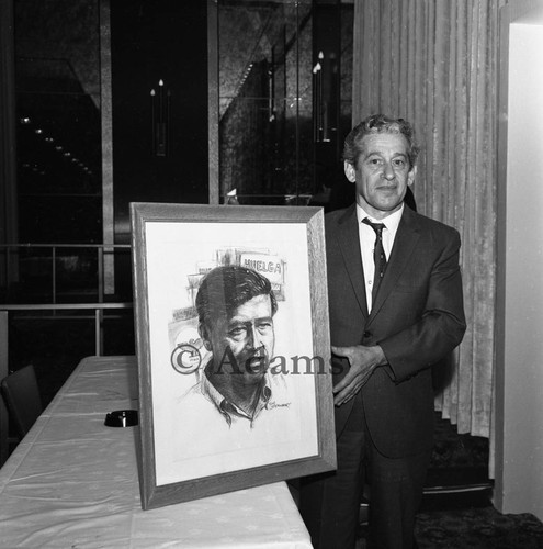 Holding a portrait, Los Angeles, 1966