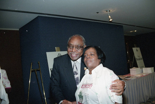 Rev. Cecil "Chip" Murray posing with a women at the National Newspaper Publishers Association convention, Los Angeles, 1993