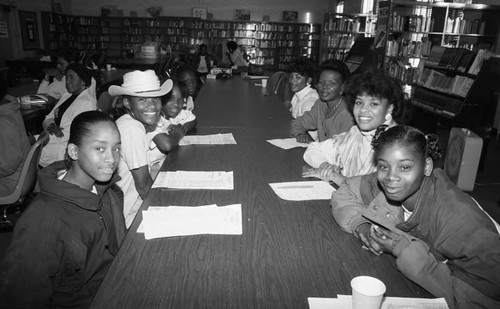 Women and young girls posing together in the library, Los Angeles, 1989