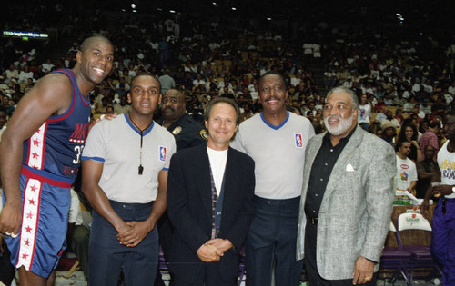 Magic Johnson posing with Billy Crystal and others at the Great Western Forum, Inglewood, 1994