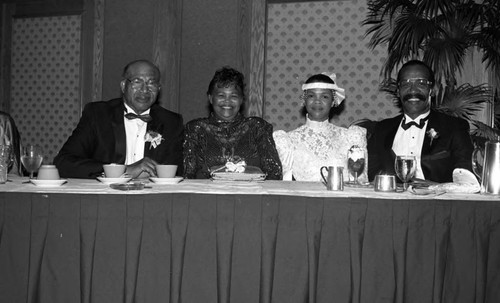 Bishop Wayne S. Davis sitting with family at the First Apostolic Church inaugural banquet, Los Angeles, 1987