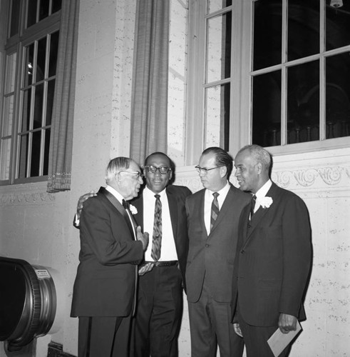 Dr. H. Claude Hudson talking with others at his testimonial dinner, Los Angeles, 1969