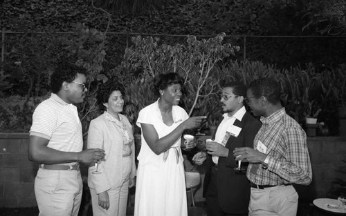 Guests talking during an event at the home of Dr. James Crayton, Los Angeles, 1983