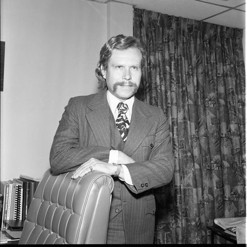 Ron Berryman posing in his office, Los Angeles, 1979