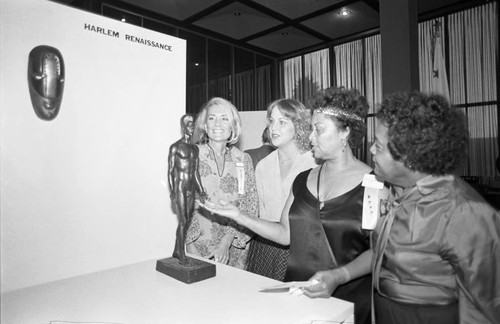Women viewing the Harlem Renaissance exhibit at the Greater Savings and Loan Association, Los Angeles, 1982
