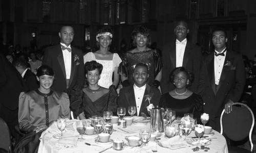 Wendy and Whitney Davis posing with guests at the First Apostolic Church inaugural banquet, Los Angeles, 1987