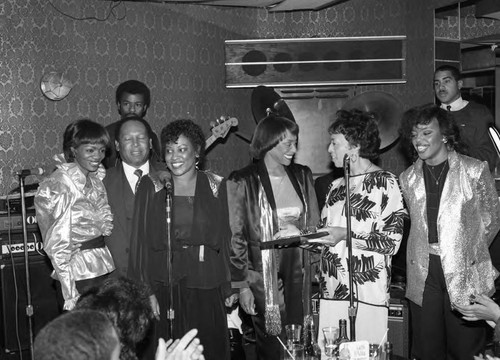 Gertrude Gipson presenting an award to the singing group SHE,Los Angeles, 1983